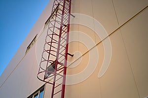 Outdoor fire escape ladder on industrial building wall