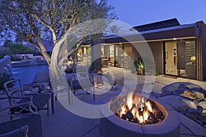 Outdoor fire place by a pool photo