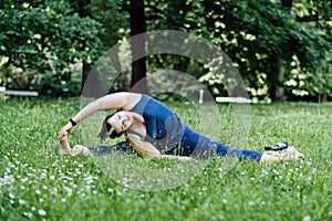 Outdoor Fitness and mini workouts. Mindfulness in fitness. Plus size curvy woman doing Fitness flexibility exercise mini