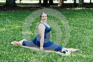 Outdoor Fitness and mini workouts. Mindfulness in fitness. Plus size curvy woman doing Fitness flexibility exercise mini