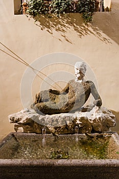 Outdoor fountain Babuino with ancient statue photo