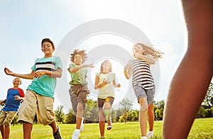 Outdoor fun in the summer sun. a group of diverse and happy kids playing together outside.