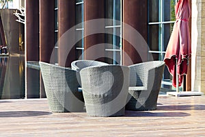 Outdoor furniture: A group of rattan armchairs on terrace