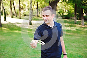 Outdoor games - guy playing ring toss in a park.