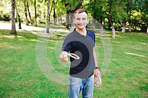Outdoor games - guy playing ring toss in a park