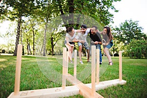 Outdoor games - ring toss, friends playing ring toss in a park.