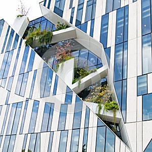 Modern high-rise building by star architect Libeskind with space for plantsc trees in facade of Koe-Bogen in Dusseldorf, Germany