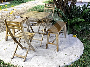 Outdoor garden table set. Empty wooden table with two chairs and two benches.