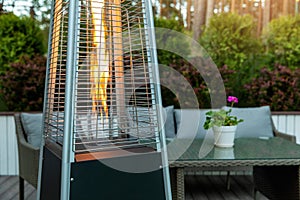 Outdoor gas pyramid heater working on terrace photo