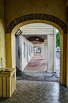 Outdoor Hallway With Arches and Tile and Brick Floor