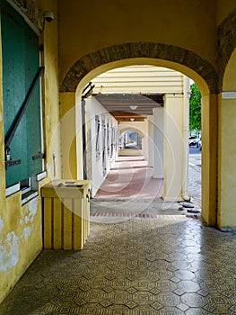 Outdoor Hallway With Arches and Tile and Brick Floor