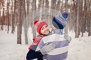 Outdoor happy couple in love posing in cold winter weather. Young boy and girl having fun outdoor