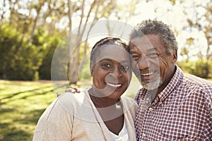 Outdoor Head And Shoulders Portrait Of Mature Couple In Park