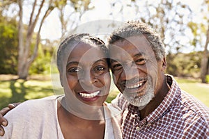 Outdoor Head And Shoulders Portrait Of Mature Couple In Park