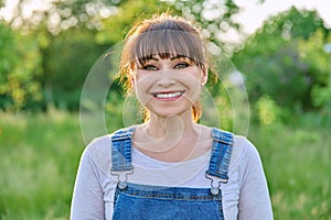 Outdoor headshot portrait of mature smiling woman in countryside