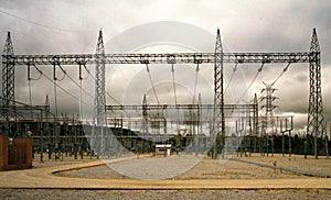 Outdoor high voltage substation with steel gantry and grey sky