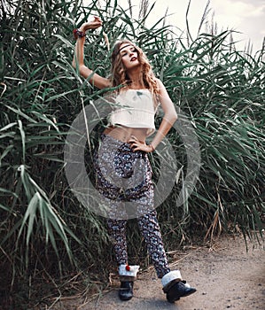 Outdoor hippie portrait of young beautiful woman. Boho chic style