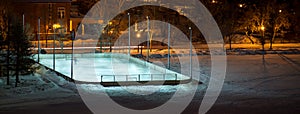 Outdoor hockey rink in a field at night