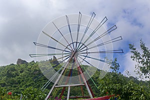 An outdoor iron pinwheel with seven colours rainbow for decoration in the park