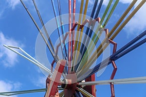 An outdoor iron pinwheel with seven colours rainbow for decoration in the park