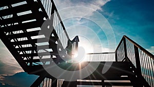 Outdoor iron staircase black color steel structure architecture construction over sunlight with beautiful blue sky background