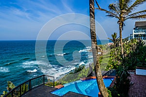 Outdoor jacuzzi and luxurious spa bath and infinity pool along Atlantic ocean in Ballito South Africa