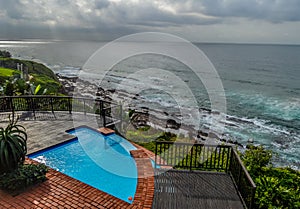 Outdoor jacuzzi and luxurious spa bath and infinity pool along Atlantic ocean in Ballito South Africa