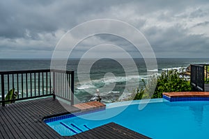 Outdoor jacuzzi and luxurious spa bath and infinity pool along Atlantic ocean in Ballito South Africa