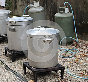 outdoor kitchen with many big cauldrons without people
