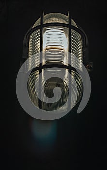 Outdoor lamp light glowing in the dark. Beautiful dusty lantern hang in front of house in the night. Exterior lighting