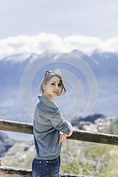 Outdoor lifestyle image, portrait of pretty girl posing at amazing mountains background