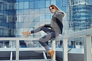 Outdoor lifestyle portrait of pretty young girl, wearing in hipster swag grunge style urban background