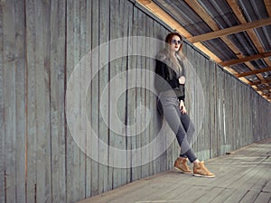 Outdoor lifestyle portrait of pretty young girl, wearing in hipster swag grunge style urban background. Retro vintage toned image