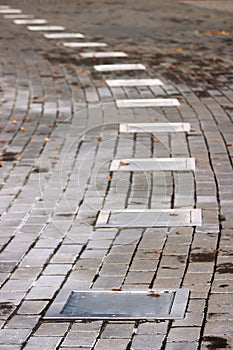 Outdoor Lighting on ground. Garden LED installed in stone pavement. path with night illumination.