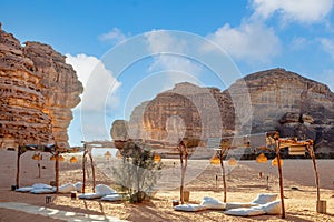 Outdoor lounge in front of elephant rock erosion monolith standing in the desert, Al Ula, Saudi Arabia photo