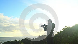 Outdoor, man and photographer with a view, camera and lens flare with ocean, capture moment or travel. Professional, guy
