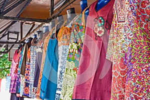 Outdoor market colorful dresses hanging