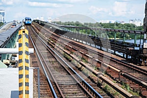 Outdoor metro rails and bright blue wagon