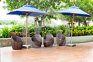 Outdoor modern chair and blue parasol