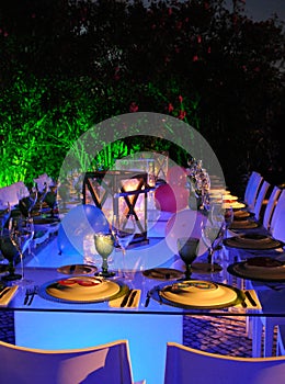 Outdoor Modern Restaurant, Lighted Candles and Tables, White Napkins, Funny Table Set