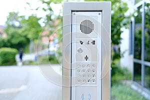 outdoor modern wireless interphone in front of office, intercom to communicate with visitors, stand-alone communication tool, photo