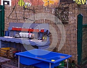 Outdoor mud kitchen with blue sandpit