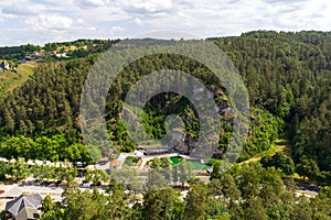 Outdoor natural pool Felsenbad Pottenstein and hill panorama in Franconian Switzerland, Germany