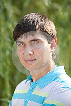 Outdoor natural portrait of a young man