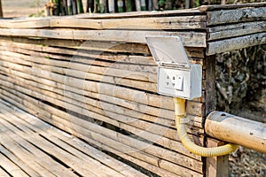 Outdoor old lighting switch on bamboo panel