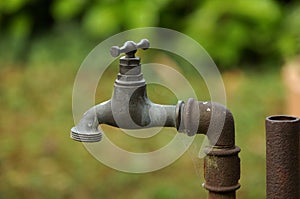 Outdoor old tap water with rusty pipes