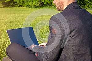 Outdoor online business technology. Student boy work with laptop tablet, computer in nature outside. Person man sitting