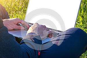 Outdoor online business technology. Student boy work with laptop tablet, computer in nature outside. Person man sitting in summer