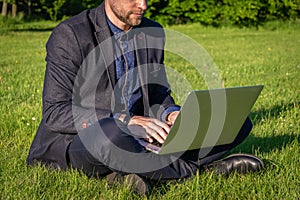 Outdoor online business technology. Student boy work with laptop tablet, computer in nature outside. Person man sitting