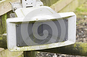 Outdoor PA speaker attached to fence